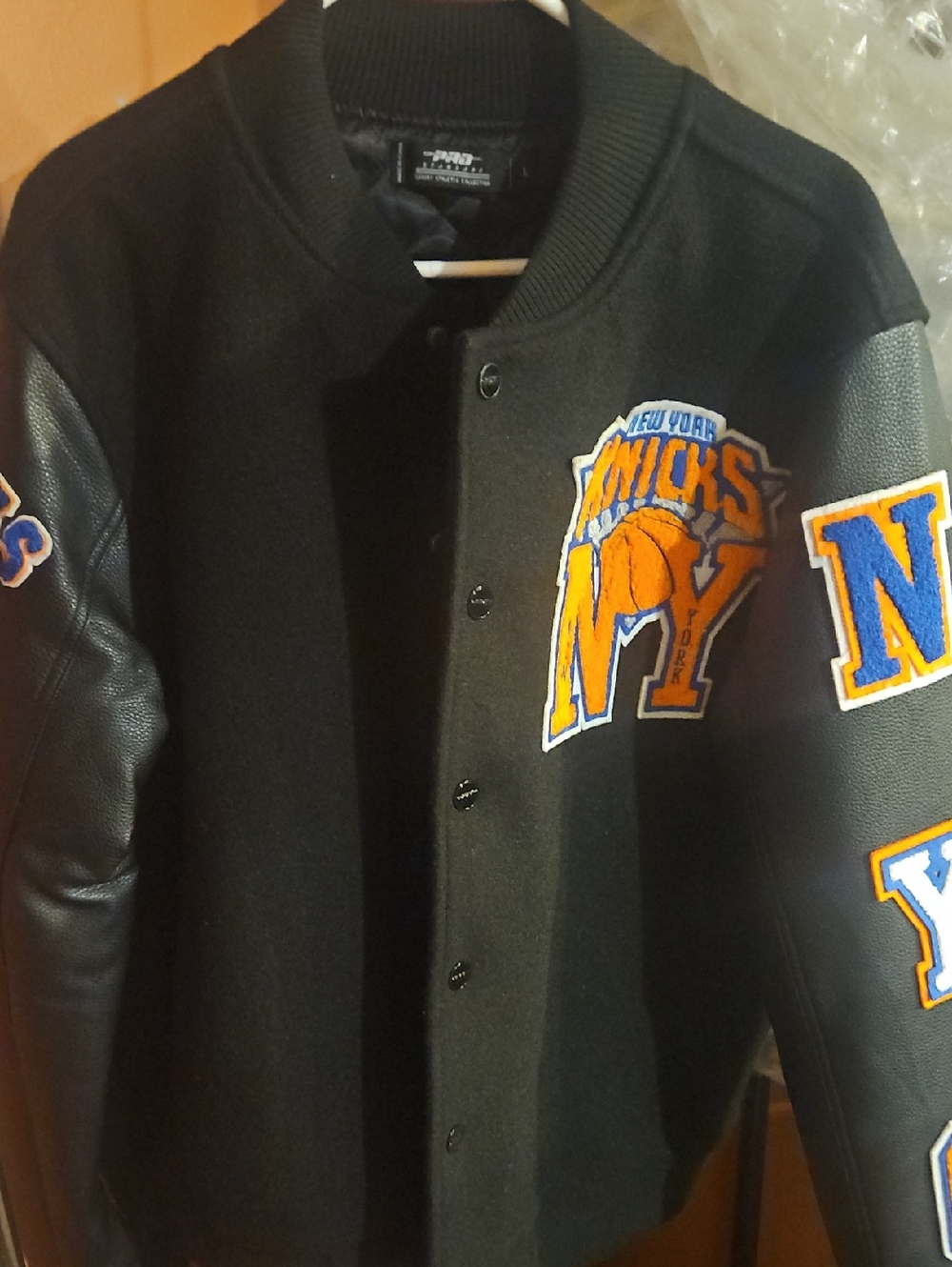 Black Varsity Bomber Jacket with Orange & Blue Knicks Patch